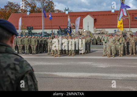 U.S. Army Soldiers with 3rd Battalion, 8th Cavalry Regiment (3-8 CAV) and 1st Battalion, 185th Infantry Regiment along with soldiers from the Romanian Army “Transylvanian Gepards” Battery, British Army “Black Dragons” Troop, Polish Armed Forces 15th Mechanized Infantry Brigade and Croatian Army from “Archer” Battery stand in formation during a Hand Over, Take Over ceremony in Bemowo Piskie, Poland, Oct. 4, 2022. The 3-8 CAV is among other units assigned to the 1st Infantry Division, proudly working alongside NATO allies and regional security partners to provide combat-credible forces to V Corp Stock Photo