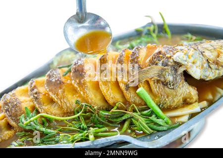 Die cut of Deep fried snakehead Fish in Spicy Sour Soup on white isolated. Stock Photo