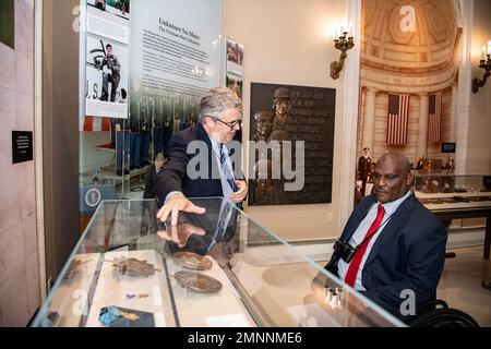 Rob Gainer (left), historian, Arlington National Cemetery, gives a tour of the Memorial Amphitheater Display Room to U.S. Army Col. (ret.) Gregory Gadson (right) at Arlington National Cemetery, Arlington, Va., Oct. 4, 2022. Gadson was at ANC to speak to employees as part of the National Disability Employment Awareness Month. He also participated in a Public Wreath-Laying Ceremony at the Tomb of the Unknown Soldier. Gadson has dedicated himself to the work of Wounded Warriors, veterans, and other groups who support employment and betterment of person with disabilities. Stock Photo