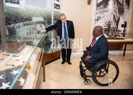 Rob Gainer (left), historian, Arlington National Cemetery, gives a tour of the Memorial Amphitheater Display Room to U.S. Army Col. (ret.) Gregory Gadson (right) at Arlington National Cemetery, Arlington, Va., Oct. 4, 2022. Gadson was at ANC to speak to employees as part of the National Disability Employment Awareness Month. He also participated in a Public Wreath-Laying Ceremony at the Tomb of the Unknown Soldier. Gadson has dedicated himself to the work of Wounded Warriors, veterans, and other groups who support employment and betterment of person with disabilities. Stock Photo