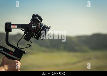 Compact Three-axis stabilizer Zhiyun Weebill S in operator hand outdoor Stock Photo