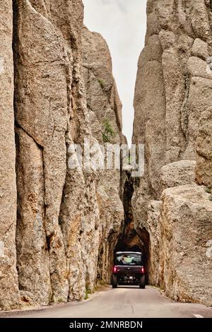 The narrow entrance between two towering stone spires Needles highway in a summer landscape Stock Photo