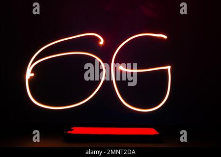 Abstract red lines long exposure light shape of 6G. Network internet mobile wireless business concept Innovations in the future 6G cellular and Internet speeds.  Stock Photo