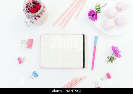 Berries smoothie with straws, marshmallow and pink anemones with copy space on white background. Flat lay. Stock Photo