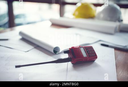 Radio communications ,blueprints and safety helmet for engineers. Stock Photo