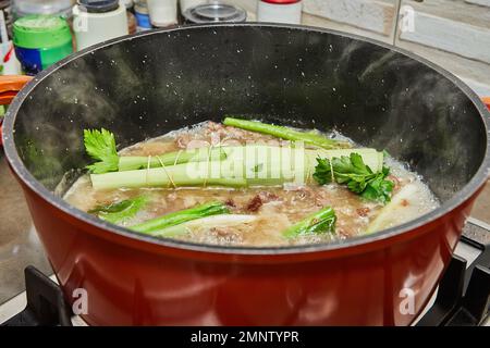 Finished bouquet of greens is placed in saucepan for dressing the dish. Stock Photo