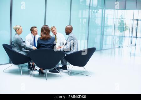 Business people in healthy discussion. Portrait of multi ethnic business people in healthy conversation. Stock Photo