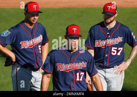 Minnesota Twins pitchers, from left, Jose Lugo, Jeff Manship and Rob  Delaney follow drills on the first day of full squad workout at baseball  spring training in Fort Myers, Fla., Saturday, Feb.