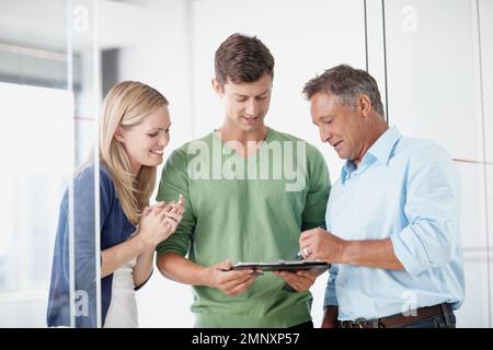 Doing some brainstorming. Three work colleagues discussing something work related. Stock Photo