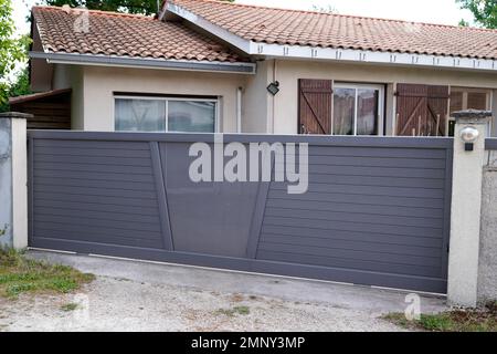 portal aluminum sliding grey metal gate of modern suburb house entrance Stock Photo