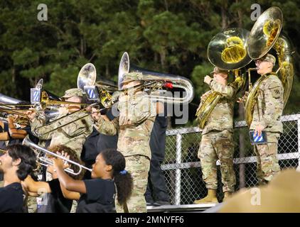 The 3rd Infantry Division Band performs with the Richmond Hill High School Marching Band during their Military Appreciation Football Game against Camden County in Richmond Hill, Georgia, Oct. 7, 2022. The 3rd ID Band performed the national anthem with the Richmond Hill High School Marching Band and Rep. Earl “Buddy” Carter received the honor of the coin toss to determine the kicking team. The 3rd ID coordinates opportunities to give back and get to know the communities that support the division, ensuring the public can see and interact with its Army. Stock Photo