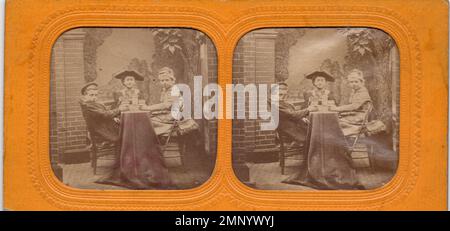 Three boys share drinks at table in costumes - tissue stereoview from Treadwell collection Stock Photo