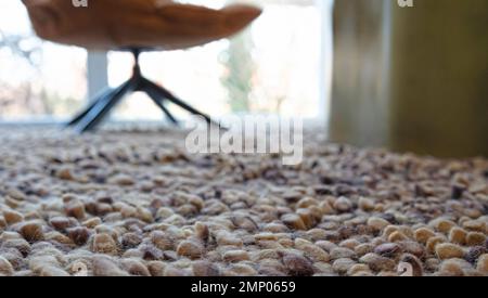 Closeup of carpet, useful as background, chair in the background Stock Photo
