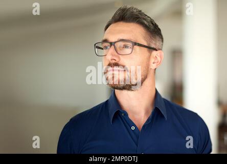 Doing some reflecting. a man standing in his home looking thoughtful. Stock Photo