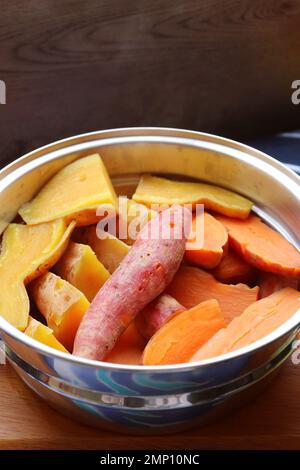 Pile of Steamed Tricolor Sweet Potatoes in a Steaming Pot Stock Photo