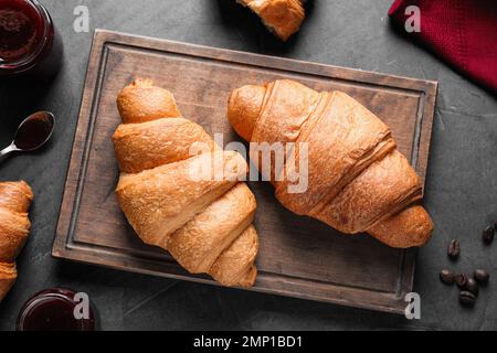 Flat lay composition with tasty croissants on grey table Stock Photo