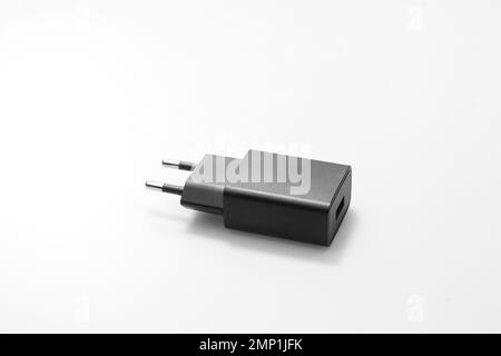 Black Network adapter 220V USB charging on a white background close-up Stock Photo