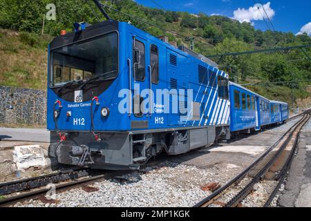 Queralbs station and engine of the Cogwheel railway Cremallera de Núria train in the Vall de Núria valley, Pyrenees, northern Catalonia, Spain, Europe Stock Photo
