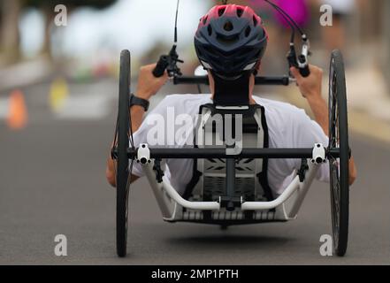 Disabled athlete in a sport wheelchair during marathon Stock Photo