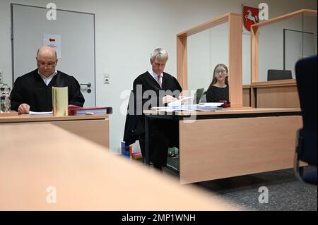 Papenburg, Germany. 31st Jan, 2023. Lawyers Oliver Prinz (l) and Heiner Thölke (m), defense attorneys for the defendants, sit in the courtroom before the trial begins. In connection with animal welfare violations in a pig farm in Emsland, two defendants must answer to the Papenburg District Court. Credit: Lars Klemmer/dpa/Alamy Live News Stock Photo