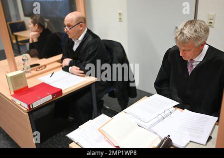 Papenburg, Germany. 31st Jan, 2023. Lawyers Oliver Prinz (m) and Heiner Thölke (r), defense attorneys for the defendants, sit in the courtroom before the trial begins. In connection with animal welfare violations in a pig farm in Emsland, two defendants must answer to the Papenburg District Court. Credit: Lars Klemmer/dpa/Alamy Live News Stock Photo