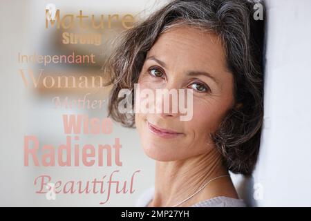 Words overlay, letter collage and portrait of a mature woman face in retirement against a wall. Positive word message, smile and isolated female with Stock Photo