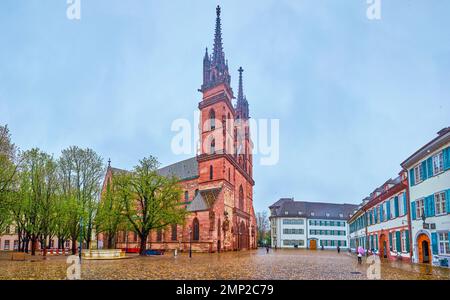 BASEL, SWITZERLAND - APRIL 1, 2022: Panorama of historic Munsterplatz (Minster Cathedral) square with Gothic styled Basel Minster cathedral, on April Stock Photo