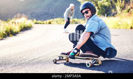 Road, skateboard sports and man skating for fitness, exercise and wellness. Training, sunglasses and male skater sitting on board, skateboarding and Stock Photo