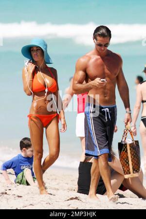 Exclusive!! Lorenzo Lamas' ex-wife Shauna Sand shows off her curves in the Miami heat today.  Reports are the Playboy Playmate and model has left LA to spend the summer in Miami and has reportedly angered Lamas in the process (the couple have three daughters together).  She spent the afternoon topping up her tan with Hawaiian Tropic oil in the company of a buff looking male friend before taking a stroll along the surf together.  Miami. FL, 4/23/08. Stock Photo