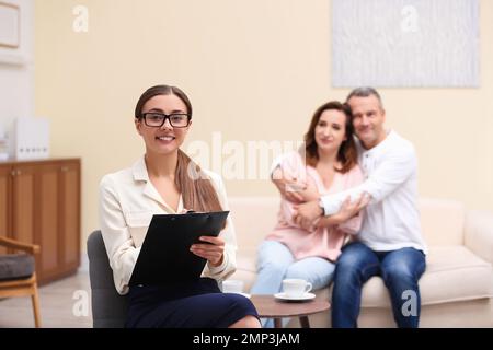 Psychotherapist and happy couple having meeting in office. Family counselling Stock Photo
