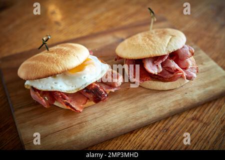 Breakfast fry up brunch gastro pub full english beans bap tomato black pudding potato hash brown scrambled egg bacon tasty food meal classic Stock Photo