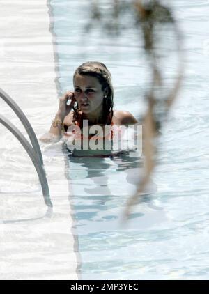 Alex Curran and Steven Gerrard lounge by the pool and take a dip to ...