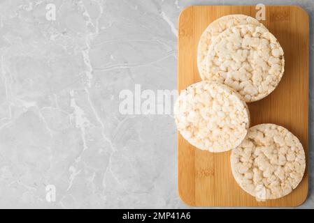 Crunchy rice cakes on grey marble table, top view. Space for text Stock Photo