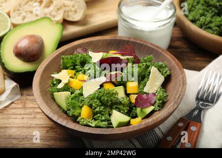 Delicious kale salad served on wooden table Stock Photo