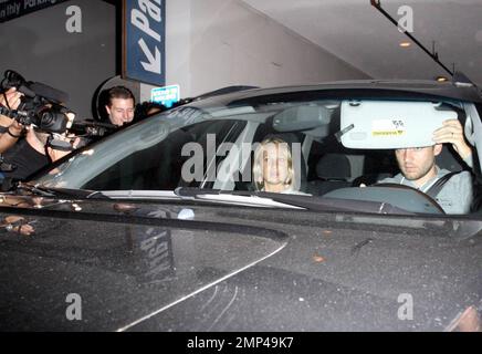 Tobey Maguire and his wife leave the restaurant Madeos after dinner and Tobey is very angry that the paparazzi are at the top of the driveway. He repeatedly honks his horn and shouts for paps to get out of the way and that he can't see oncoming traffic before unbuckling his seatbelt, opening his door and slamming it into the crowd of photographers and calling one guy a 'motherf***er.' He then drives off, honking as he goes. Los Angeles, CA. 7/9/08. Stock Photo