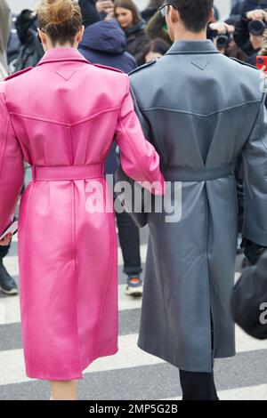 MILAN, ITALY - JANUARY 15, 2023: Woman and man with pink and gray leather  coat before Prada fashion show, Milan Fashion Week street style Stock Photo  - Alamy