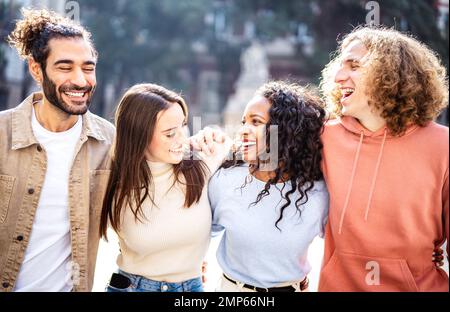Multi cultural happy couples talking and having fun at touristic destination - Friendship life style concept on young mienial people meeting out side Stock Photo