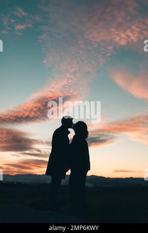 silhouette of kissing wedding couple under archway Stock Photo - Alamy