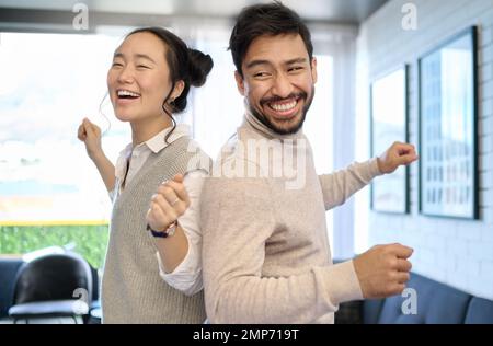 Couple, love and dance in home living room, having fun and laughing while enjoying time together. Music freedom, diversity and interracial man and Stock Photo