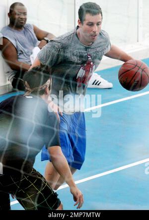 Actor Adam Sandler enjoys some downtime by playing basketball on the set of 'Jack and Jill', co-starring Katie Holmes.  Some scenes for the comedy were filmed aboard the world's largest cruise ship, Royal Caribbean's new Allure of the Seas. Fort Lauderdale, FL. 11/20/10. Stock Photo