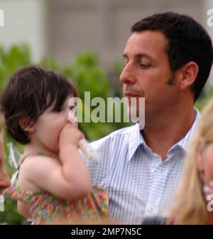 Actor Adam Sandler makes his way around the Maui set of 'Just Go With It' during a break.  Adam took some time out for his daughter, two-year-old Sunny Madeline, and happily carried her around.  Adam's daughters Sadie and Sunny are no strangers to film sets, Adam brought them along to see daddy in action while he filmed 'Grown Ups' last year.  Adam's latest comedy, 'Just Go With It', co-stars Jennifer Aniston and Nicole Kidman. Maui, HI. 05/03/10. Stock Photo