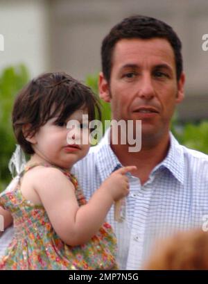 Actor Adam Sandler makes his way around the Maui set of 'Just Go With It' during a break.  Adam took some time out for his daughter, two-year-old Sunny Madeline, and happily carried her around.  Adam's daughters Sadie and Sunny are no strangers to film sets, Adam brought them along to see daddy in action while he filmed 'Grown Ups' last year.  Adam's latest comedy, 'Just Go With It', co-stars Jennifer Aniston and Nicole Kidman. Maui, HI. 05/03/10. Stock Photo