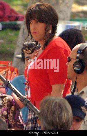 Adam Sandler, 44, shows off his smoothly shaven legs in a plaid skirt paired with a white top, red cardigan and red open-toed shoes as he films scenes for his new comedy 'Jack and Jill.' Dressed in full drag, Sandler even donned a brunette wig styled into braids and painted fingernails as he played the role of Jill during filming. In the film, Sandler also plays the character of Jack, who is forced to deal with his twin sister, Jill, when she visits for Thanksgiving and refuses to leave. Also starring in the film are Katie Holmes, who plays Jack's wife and Al Pacino who makes a cameo appearanc Stock Photo