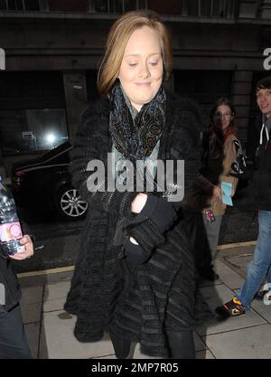 Singer Adele (aka Adele Adkins) arrives, big water bottle in hand, at the studios of BBC Radio where she promoted her upcoming second studio album '21'.  The Grammy Award winner appeared to have driven herself and gave a modest smile as she walked inside where she performed a live session on the Dermot O'Leary show. London, UK. 01/22/11. Stock Photo