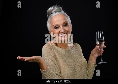 Portrait of happy senior woman with glass of wine, celebrating concept. Stock Photo