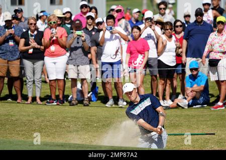 A gallery watches Jordan Spieth hit his ball out of a greenside bunker on the 11th during the third round of the Sony Open golf tournament, Saturday Jan. 13, 2018, in Honolulu. (AP Photo/Marco Garcia)