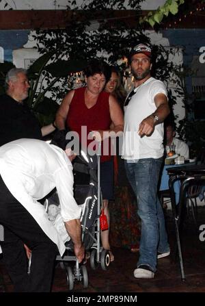 Super model Alessandra Ambrosio, fiance Jamie Mazur and their baby girl Anja Mazur enjoy a family dinner out at Taverna Tony. The happy couple walked in ahead of their daughter, who was sleeping while being pushed by a nanny in her stroller. Los Angeles, CA. 7/19/09. Stock Photo