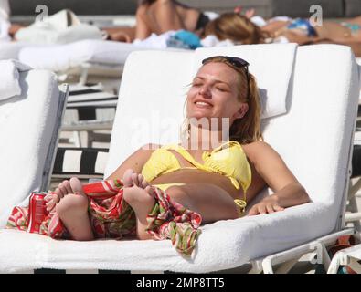 'Strictly Come Dancing' Russian dancer, Aliona Vilani soaks up the sun with friends showing off her toned body in a yellow string bikini whilst on a birthday getaway. Vilani turned 28 years old on Tuesday and decided to get some much needed rest with her relatives in Florida. The professional dancer has been working hard getting herself fit for the next series of 'Strictly Come Dancing' which has paid off and can clearly be seen as she taunts her body on the beach. Miami Beach, FL. 3rd of May, 2012. . Stock Photo