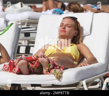 'Strictly Come Dancing' Russian dancer, Aliona Vilani soaks up the sun with friends showing off her toned body in a yellow string bikini whilst on a birthday getaway. Vilani turned 28 years old on Tuesday and decided to get some much needed rest with her relatives in Florida. The professional dancer has been working hard getting herself fit for the next series of 'Strictly Come Dancing' which has paid off and can clearly be seen as she taunts her body on the beach. Miami Beach, FL. 3rd of May, 2012. . Stock Photo