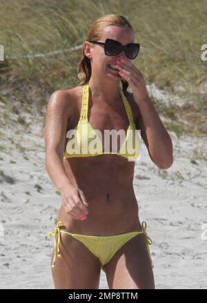 'Strictly Come Dancing' Russian dancer, Aliona Vilani soaks up the sun with friends showing off her toned body in a yellow string bikini whilst on a birthday getaway. Vilani turned 28 years old on Tuesday and decided to get some much needed rest with her relatives in Florida. The professional dancer has been working hard getting herself fit for the next series of 'Strictly Come Dancing' which has paid off and can clearly be seen as she taunts her body on the beach. Miami Beach, FL. 3rd of May, 2012. . Stock Photo